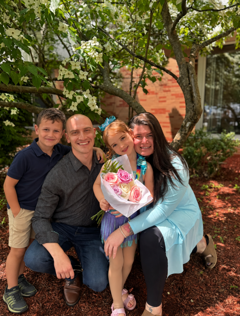 The family behind Bantel HVAC together beneath a flowering tree