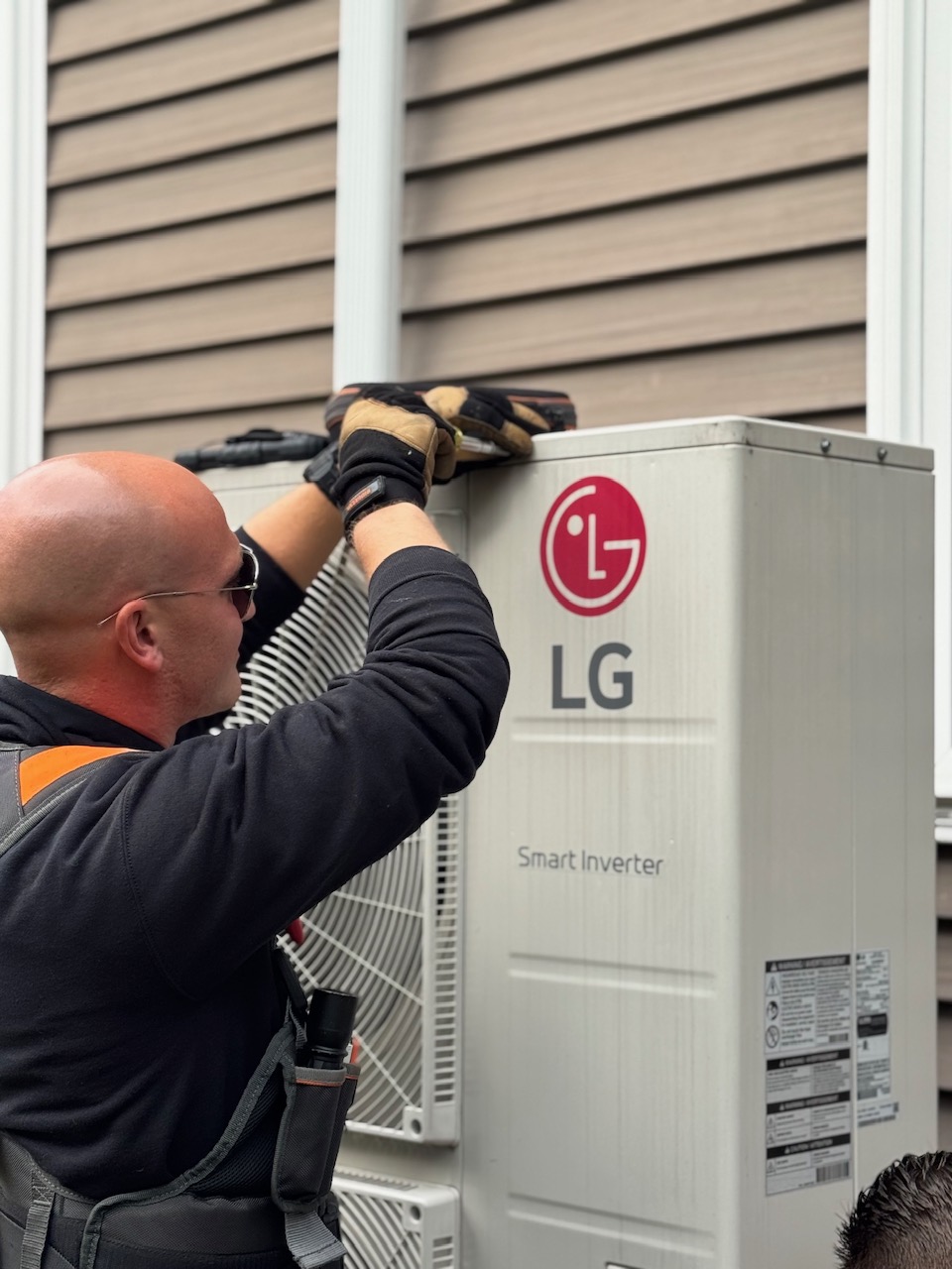 Bantel HVAC technician working on an outdoor air conditioning unit